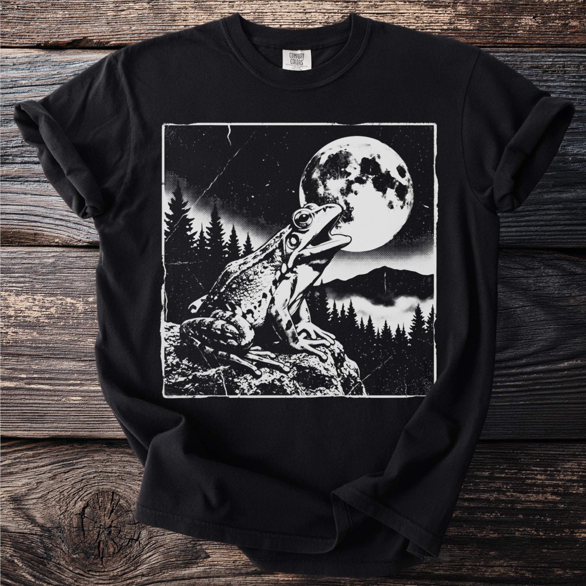 Black t-shirt with a monochrome graphic of a frog croaking at the full moon.