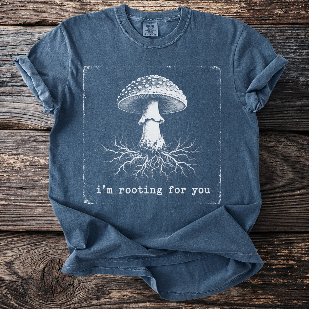 Blue t-shirt with a white mushroom illustration and text "i'm rooting for you".