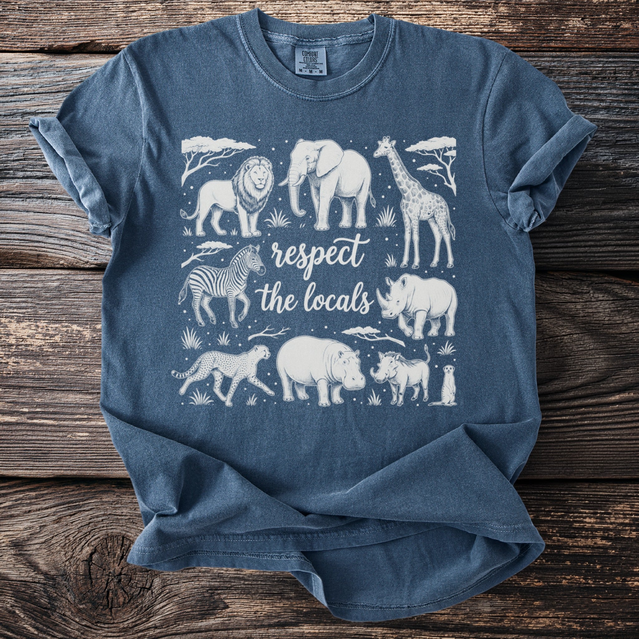 Blue t-shirt with safari animals and text "respect the locals" in white.