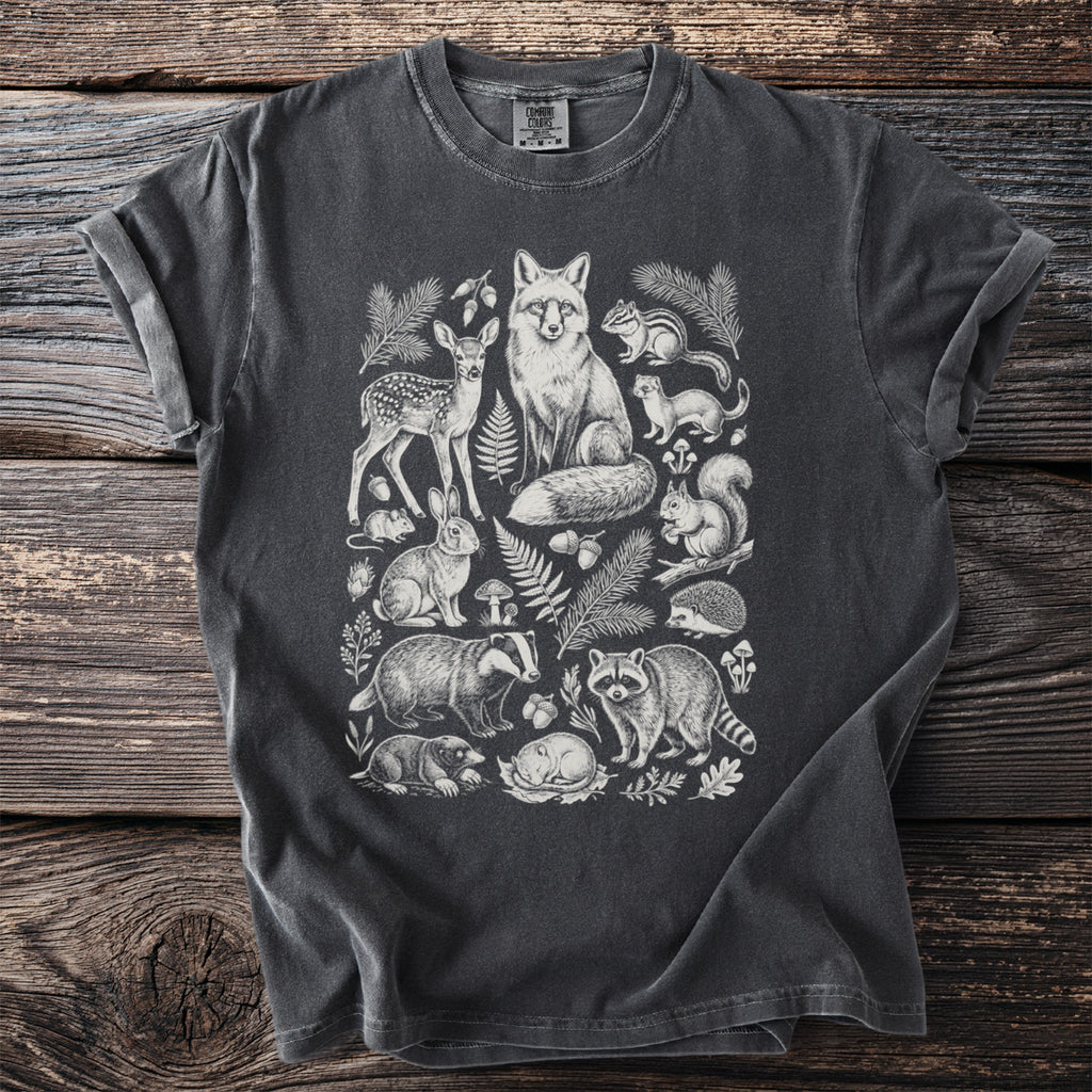 Charcoal t-shirt with a white line drawing of forest animals and foliage.