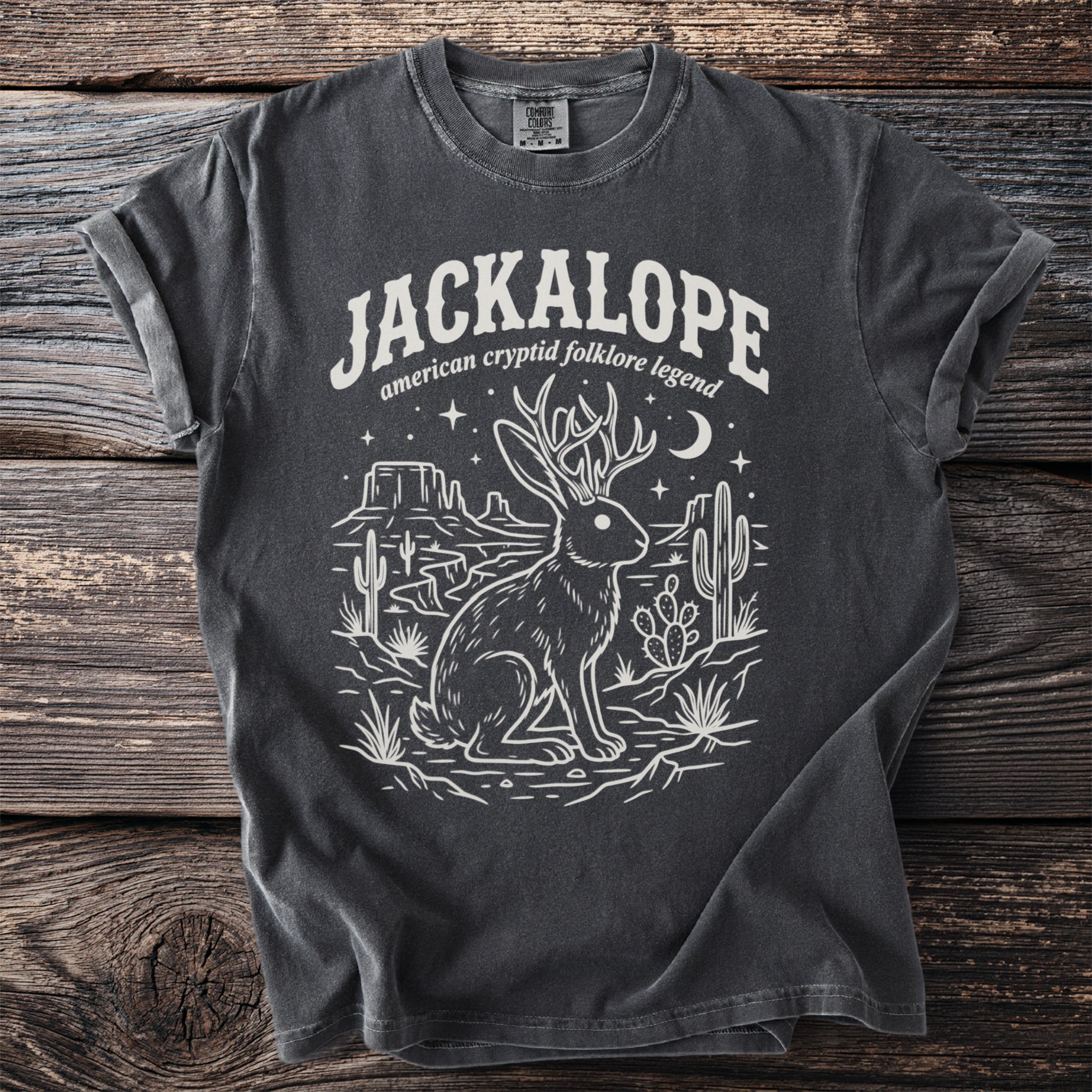 Charcoal t-shirt with "Jackalope american cryptid folklore legend" and desert graphic.