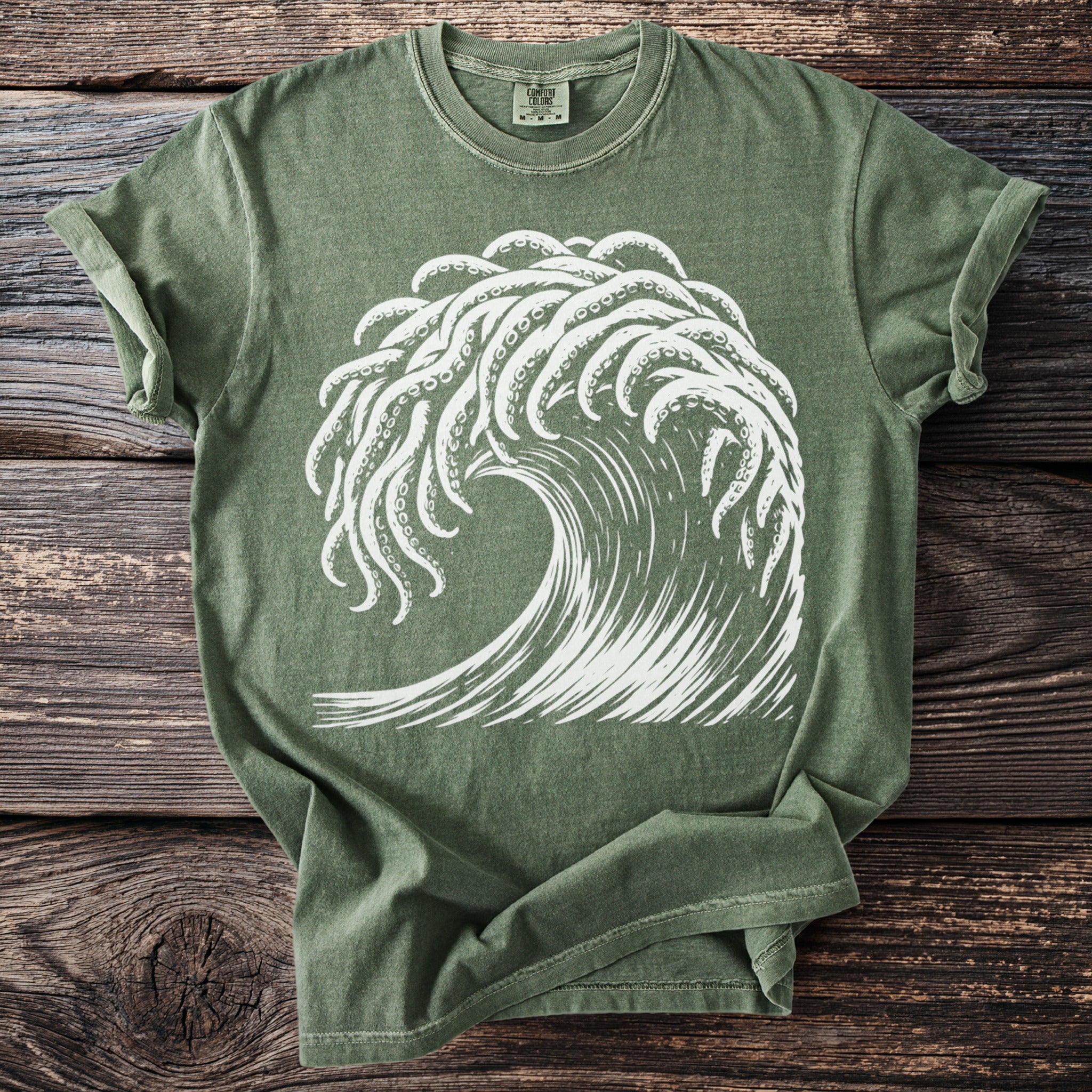 Green t-shirt with white wave and tentacles graphic, Comfort Colors tag.