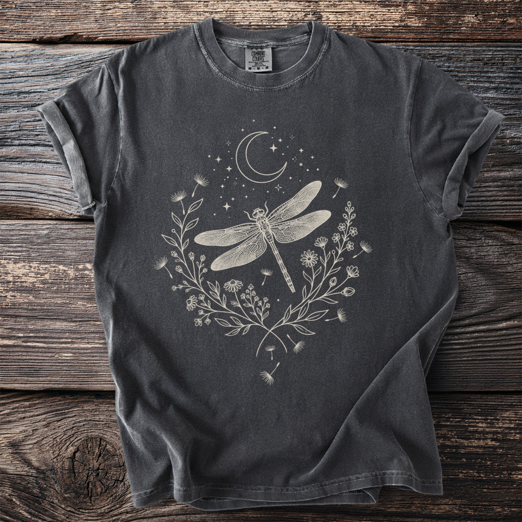 Dark grey t-shirt with a pale graphic of a dragonfly, crescent moon, stars, and floral wreath.