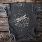 Dark grey t-shirt with a pale graphic of a dragonfly, crescent moon, stars, and floral wreath.