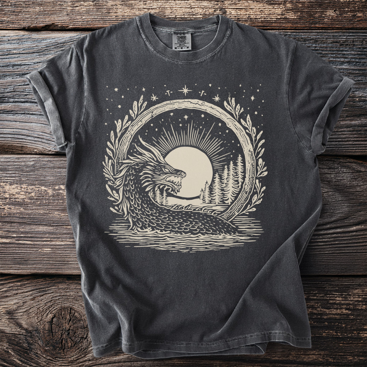 Dark gray t-shirt with a cream circular graphic of a dragon in water with trees and a moon.