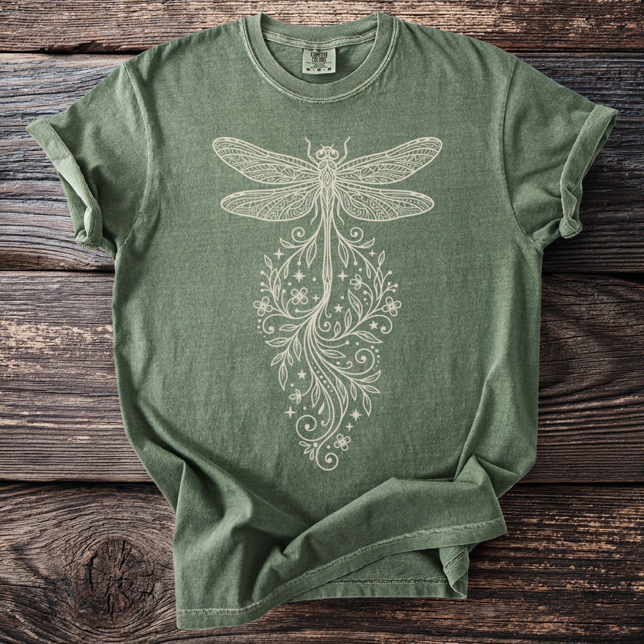 Olive green t-shirt with cream-colored dragonfly and floral design.