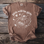 Brown t-shirt with white graphic of a spider, prey, and "girls will be girls" text.