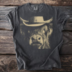 Dark gray t-shirt with a tan line drawing of a cow wearing a cowboy hat.