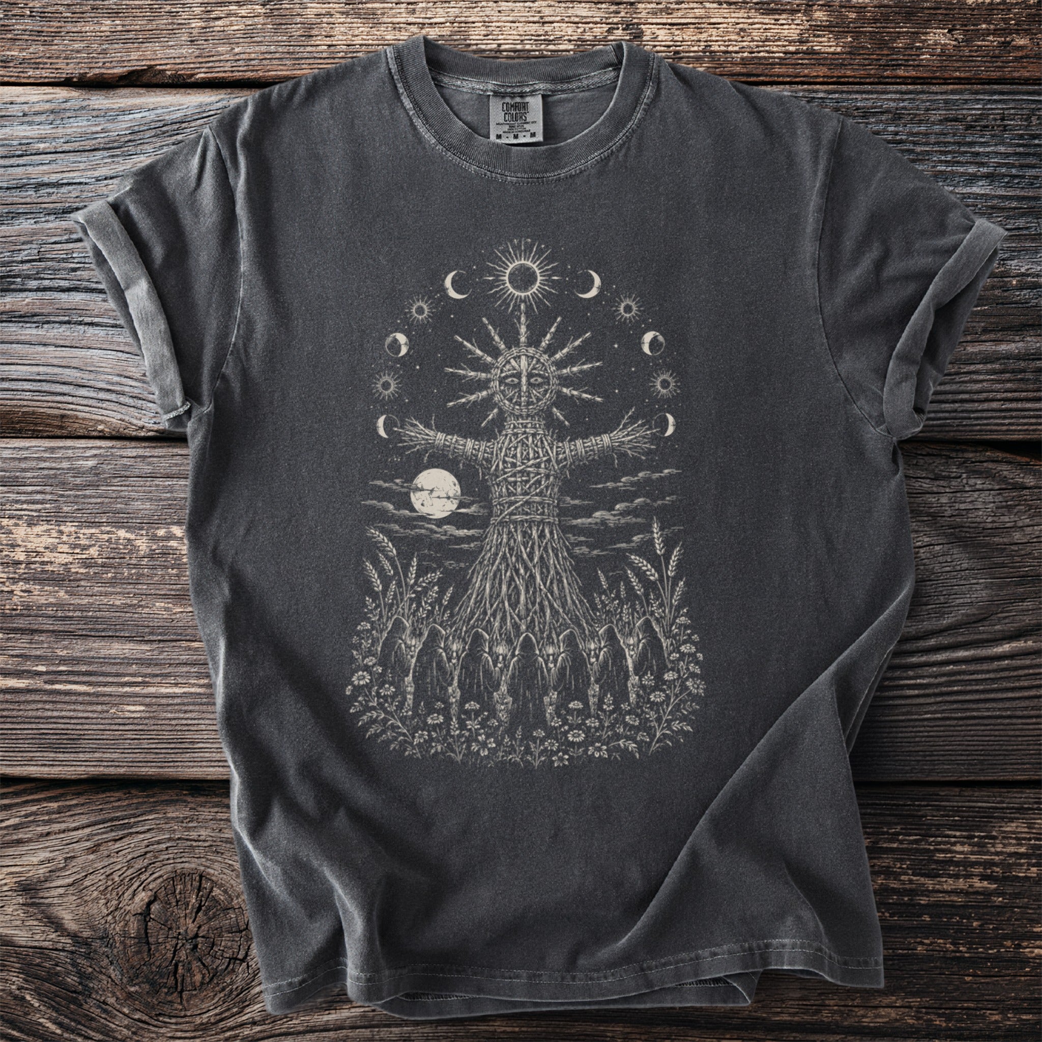 Dark grey t-shirt with a wicker effigy, moon, sun, and figures graphic.