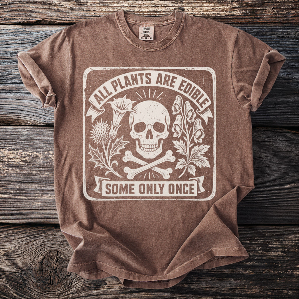 Brown t-shirt with a distressed graphic of a skull, bones, and plants with text.