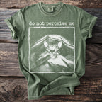 Green t-shirt with white text "do not perceive me" above a cat illustration.