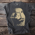 Dark t-shirt with a vintage wash and a graphic of a goose holding a pen in its bill.