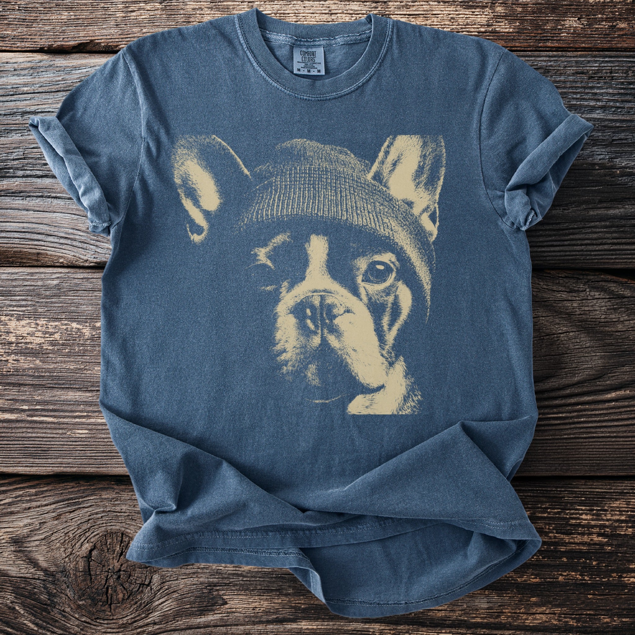 Blue t-shirt with a stencil graphic of a French bulldog wearing a beanie.