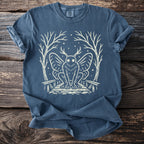Blue t-shirt with white mothman design, trees, and dots surrounding it.