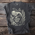 Dark gray t-shirt with a graphic of a witch, raven, house, mushrooms, and basket.