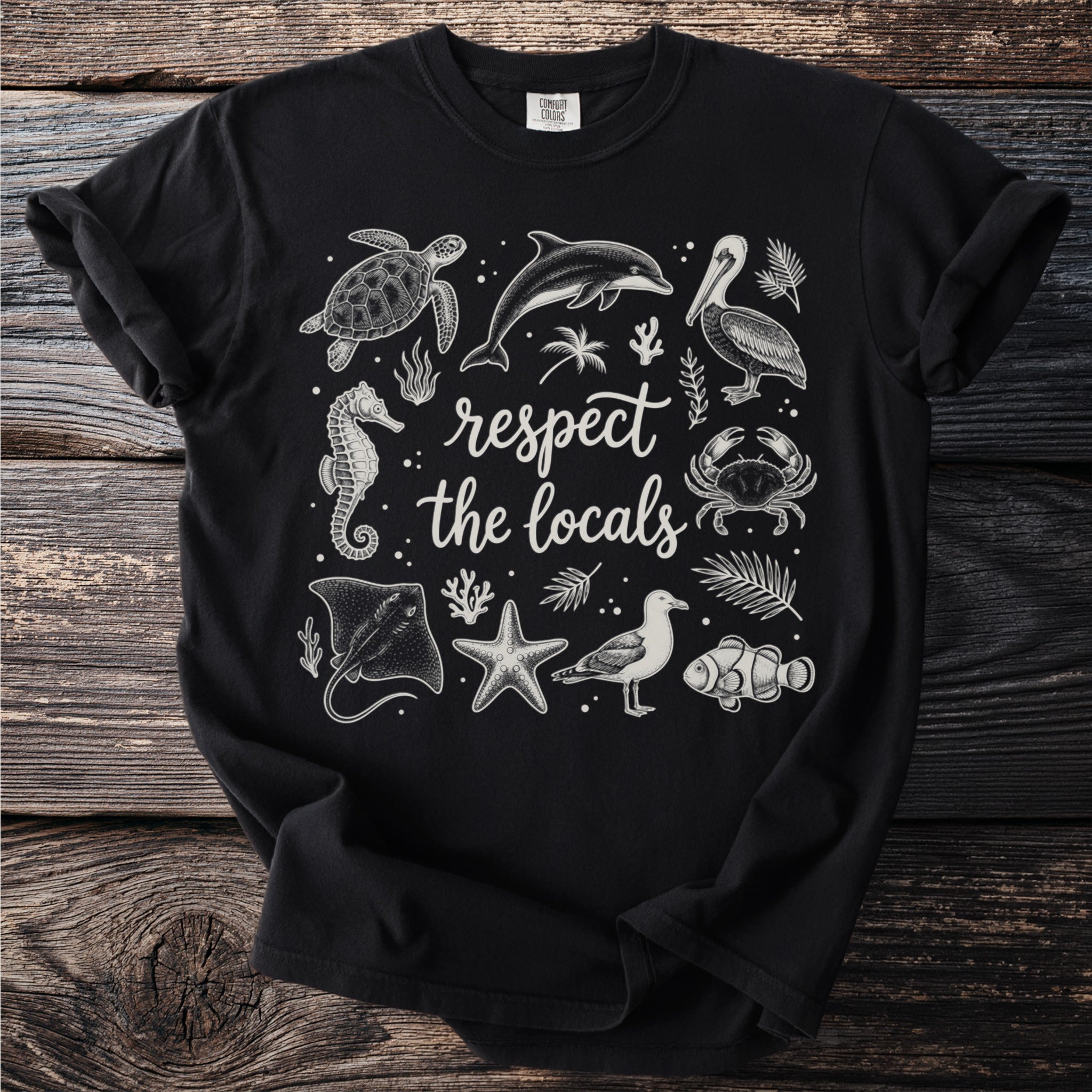 Black t-shirt with white graphic of ocean life and "respect the locals" text.