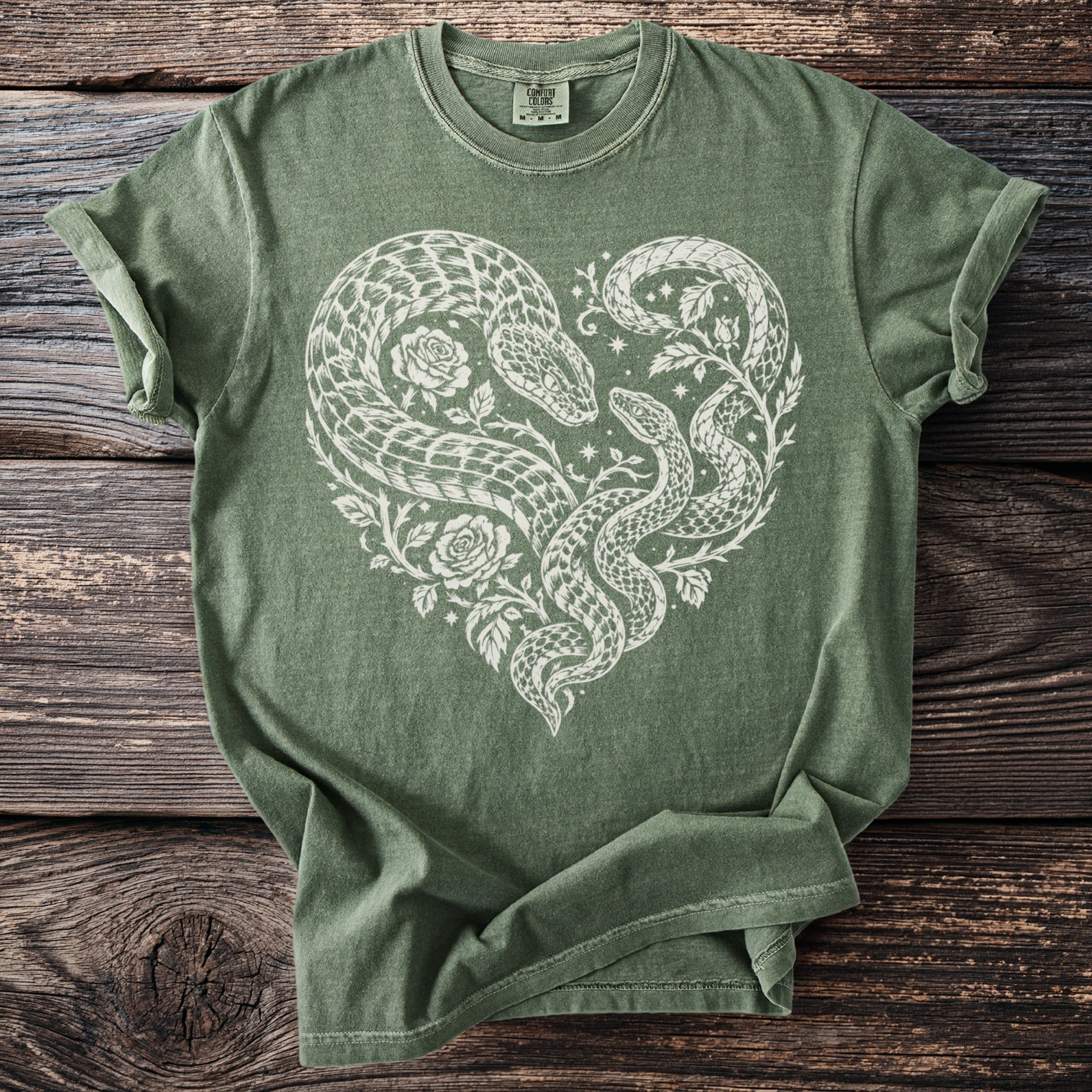 Green t-shirt with white snake heart and rose design.