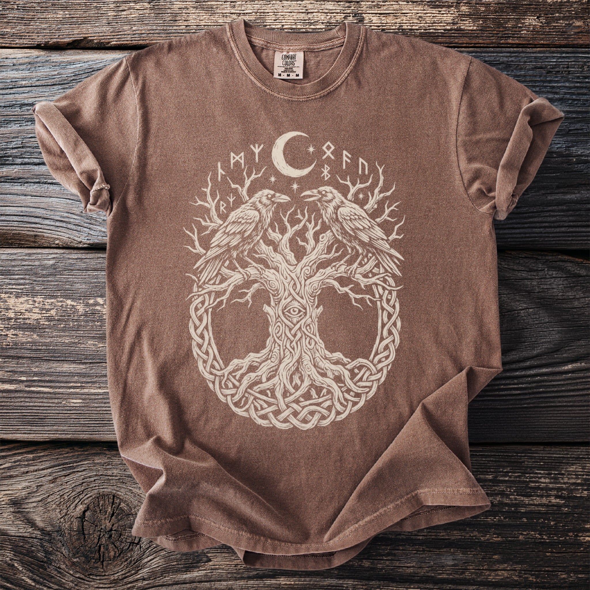 Brown t-shirt with a cream-colored graphic of Yggdrasil, ravens, moon, and runes.