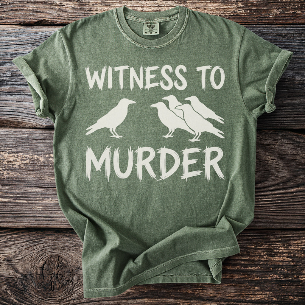 Green t-shirt with white text "WITNESS TO MURDER" and silhouette of crows.