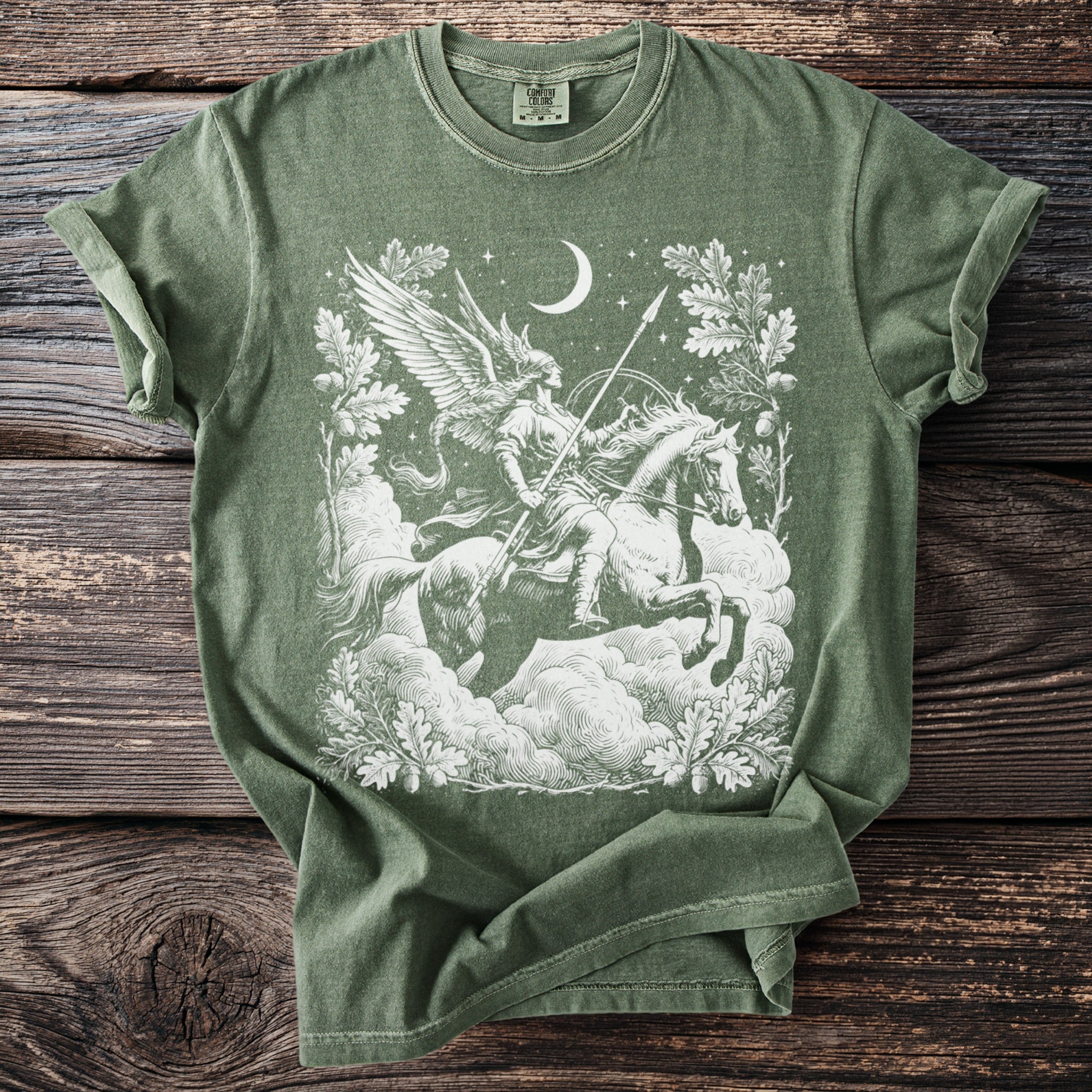 Green t-shirt with a white mythological winged figure on a horse against clouds and stars.
