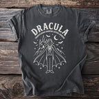 Dark grey t-shirt featuring a white line drawing of Dracula, castle, bats, and moon.