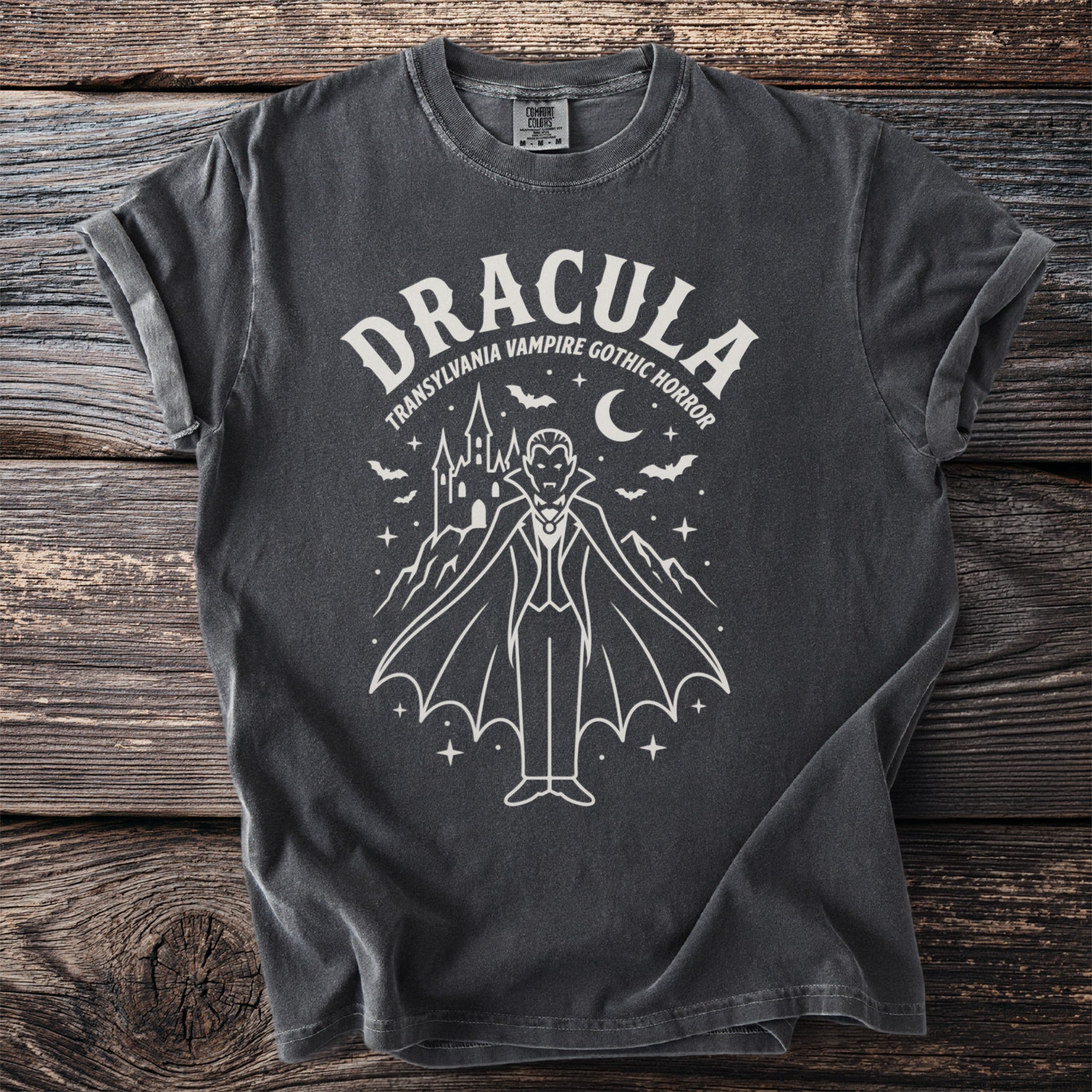 Dark grey t-shirt featuring a white line drawing of Dracula, castle, bats, and moon.