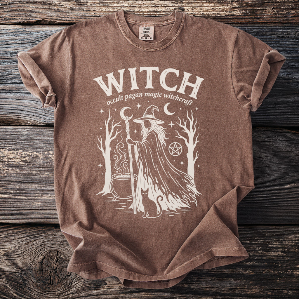 Brown t-shirt with white "WITCH" graphic featuring a witch, cauldron, cat, and stars.