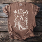 Brown t-shirt with white "WITCH" graphic featuring a witch, cauldron, cat, and stars.