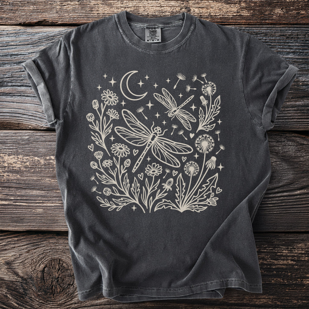 Dark grey t-shirt with outline design of dragonflies, flowers, crescent moon, and stars.
