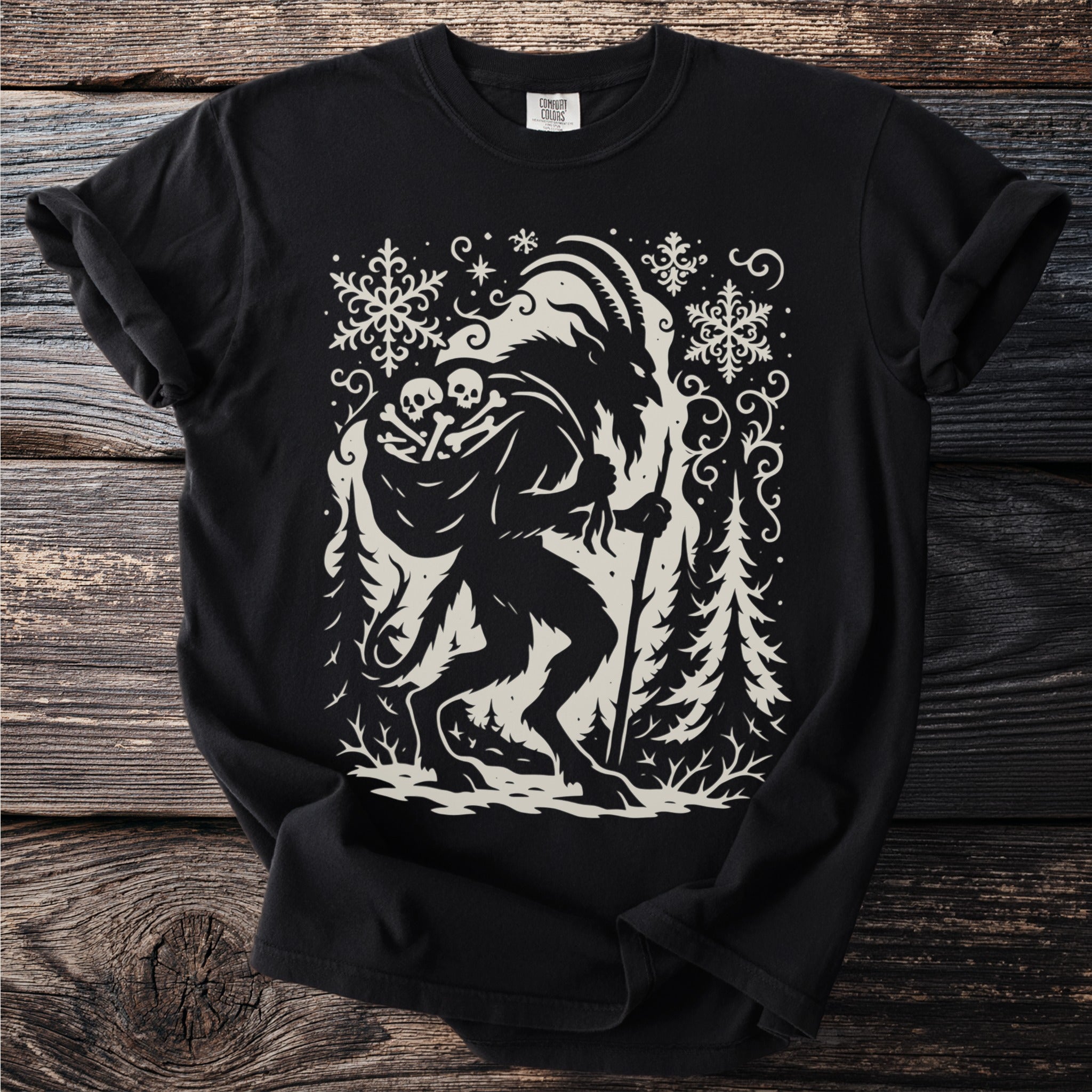 Black t-shirt with Krampus, skulls, and snowflakes graphic.