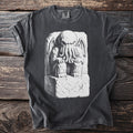 Charcoal t-shirt with a black and white illustration of a tentacled creature on a stone altar.