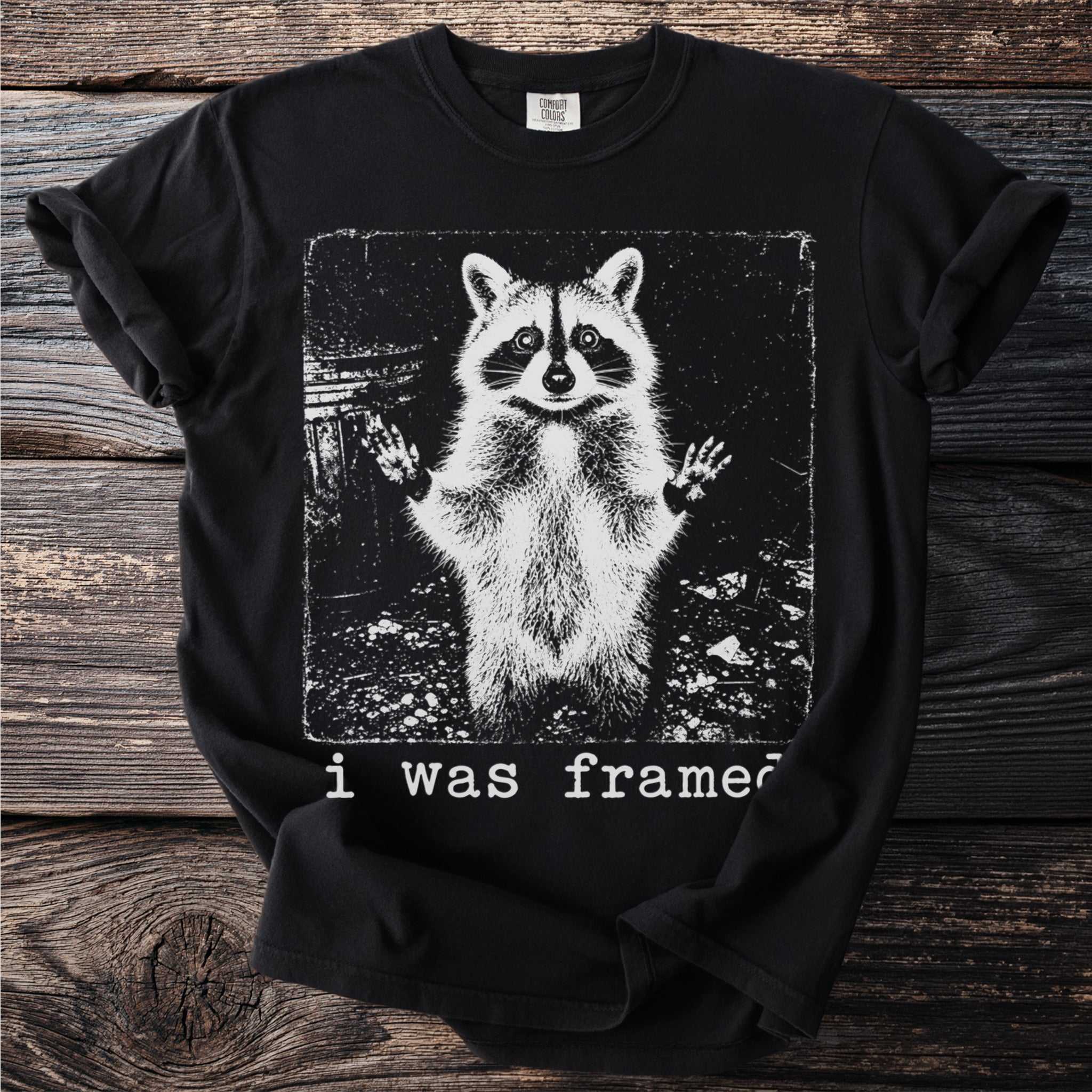 Black t-shirt with a distressed raccoon graphic and "i was framed" text.
