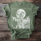Green t-shirt with a distressed print of a raccoon howling at a full moon.