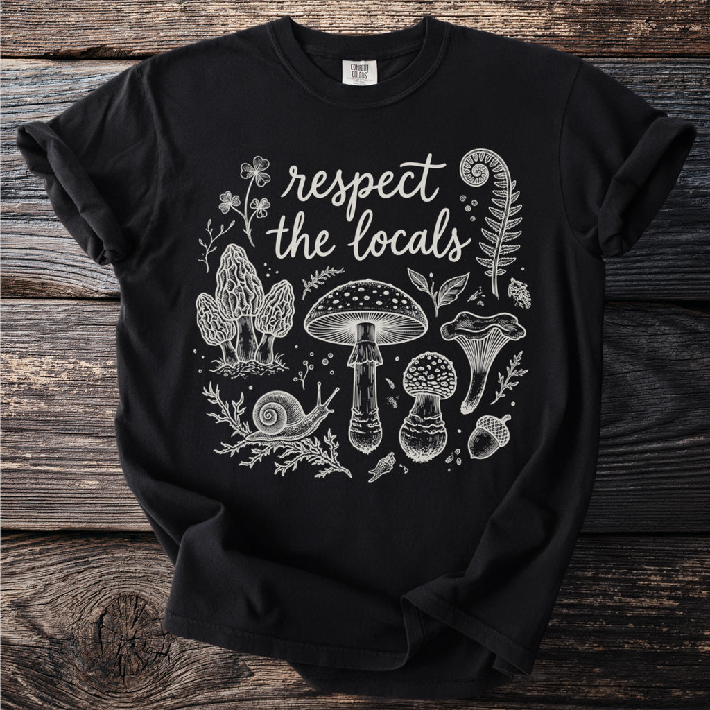 Black t-shirt with white line art of mushrooms, a snail, and leaves. Text reads "respect the locals".