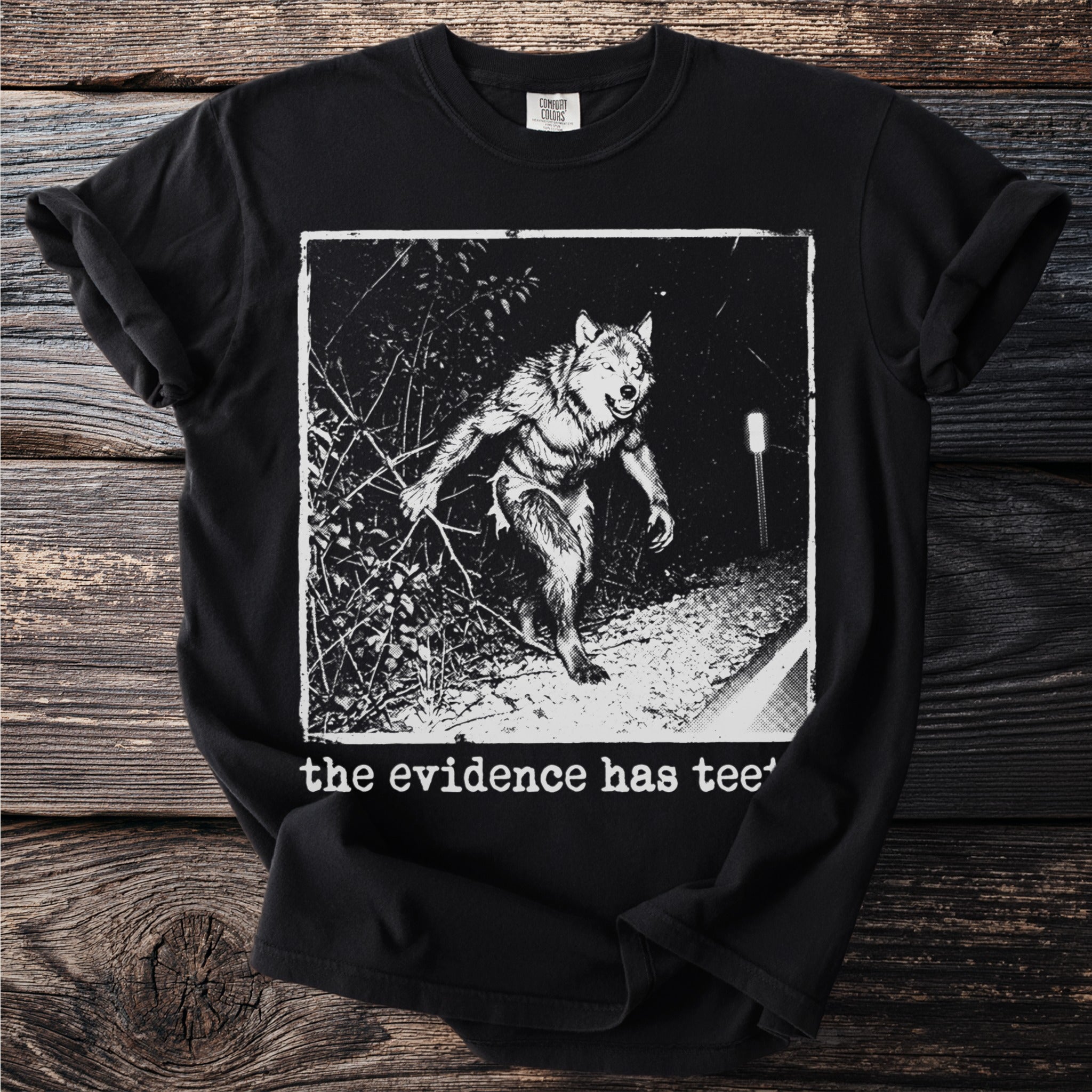 Black t-shirt with a werewolf graphic and text "the evidence has tee".