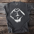 Dark gray t-shirt with white distressed graphic of a person in a hat making a heart symbol with stars.
