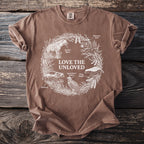 Brown t-shirt featuring "Love the Unloved" text and a circular graphic of labeled animals.
