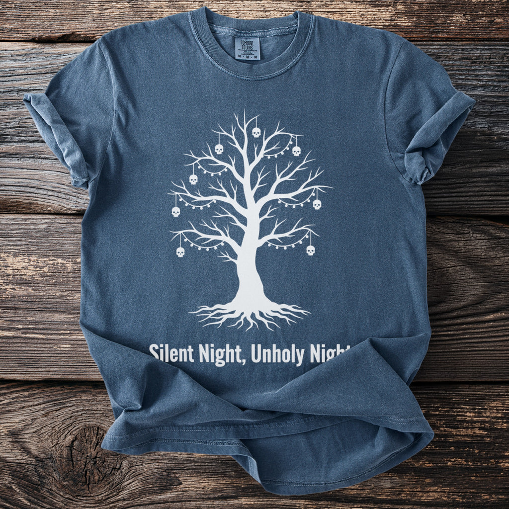 Blue t-shirt with white graphic of a bare tree with skulls and lights, text "Silent Night, Unholy Night".