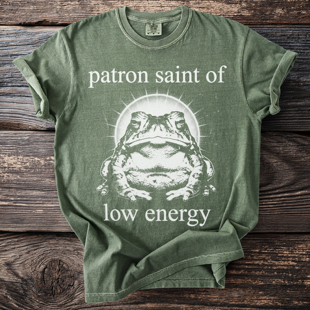 Green t-shirt with a toad graphic and text "patron saint of low energy".
