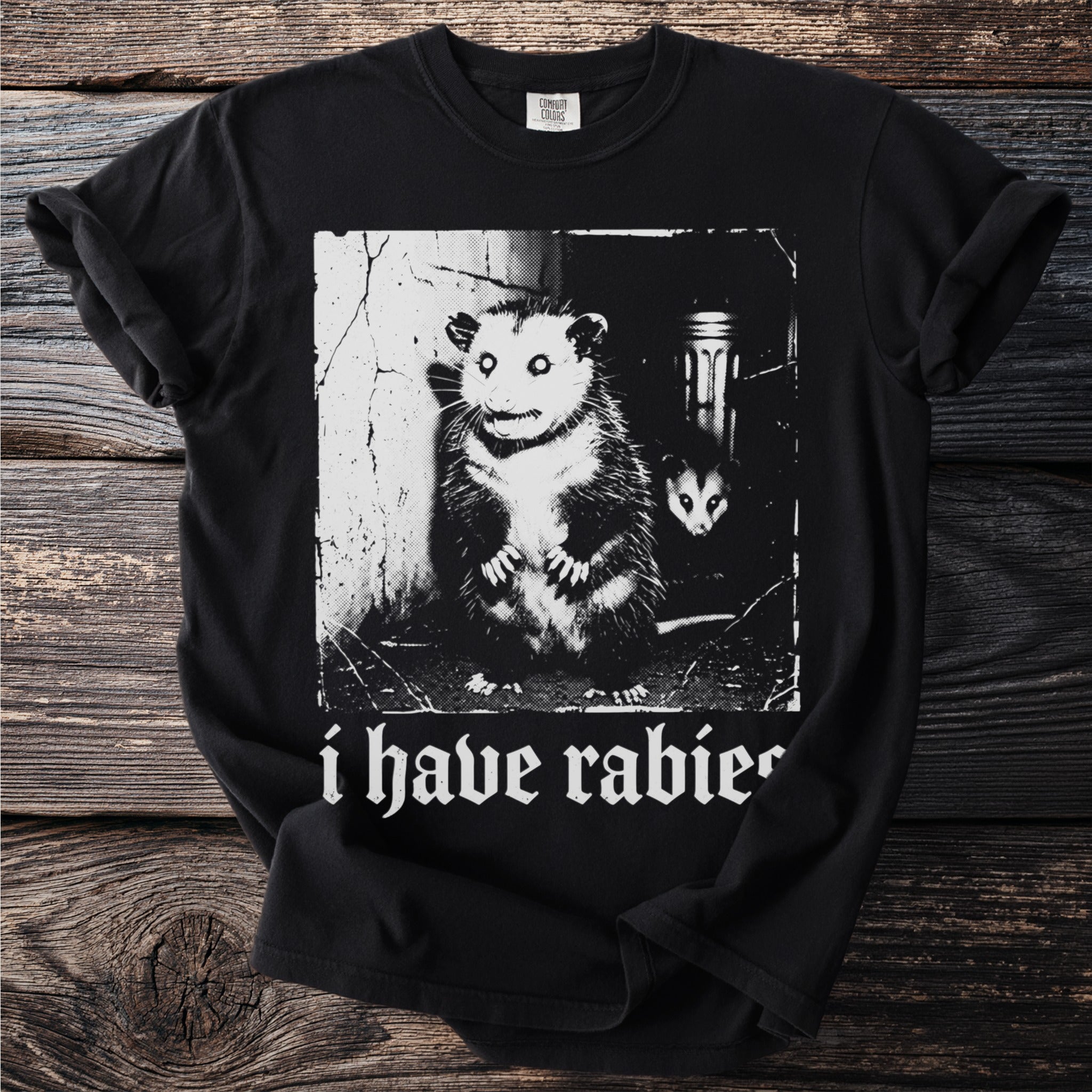 Black t-shirt with graphic of two possums and text "i have rabies".
