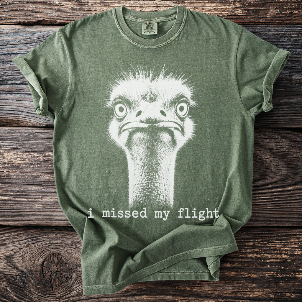 Green t-shirt with white ostrich graphic and text "i missed my flight".