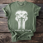 Green t-shirt with white ostrich graphic and text "i missed my flight".
