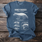 Blue t-shirt with white line drawings and text about the honey badger.