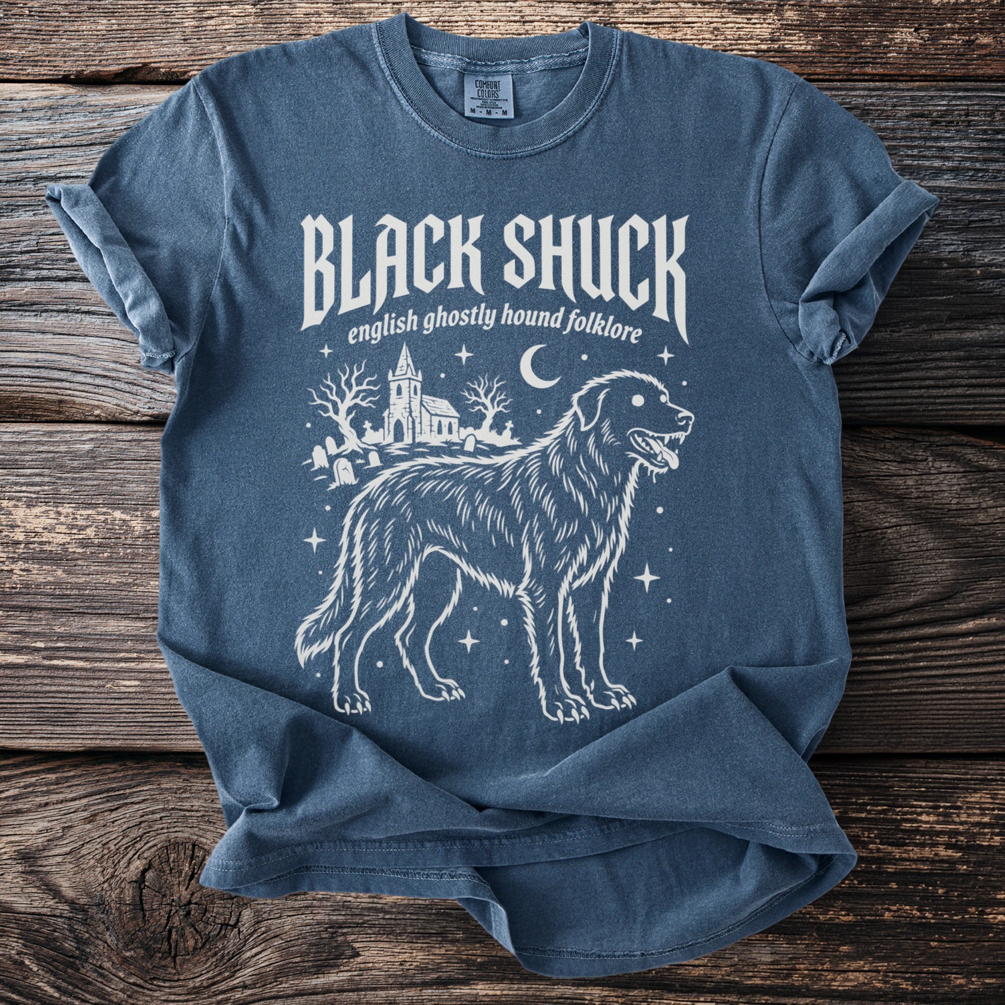 Blue t-shirt with white "Black Shuck english ghostly hound folklore" design.