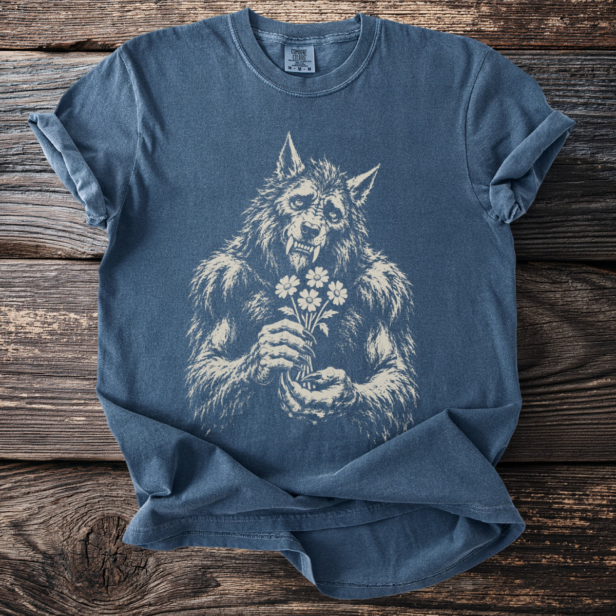 Werewolf holding a bouquet of daisies on a blue Comfort Colors t-shirt.