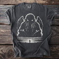 Dark t-shirt with a tentacled creature and silhouetted figure illustration.