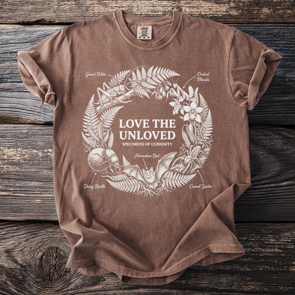 Brown t-shirt with "LOVE THE UNLOVED SPECIMENS OF CURIOSITY" and wreath of insects.