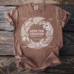 Brown t-shirt with "LOVE THE UNLOVED SPECIMENS OF CURIOSITY" and wreath of insects.