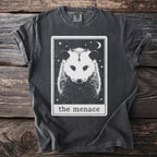 Dark gray t-shirt with a black and white tarot card design featuring an opossum and text "the menace".