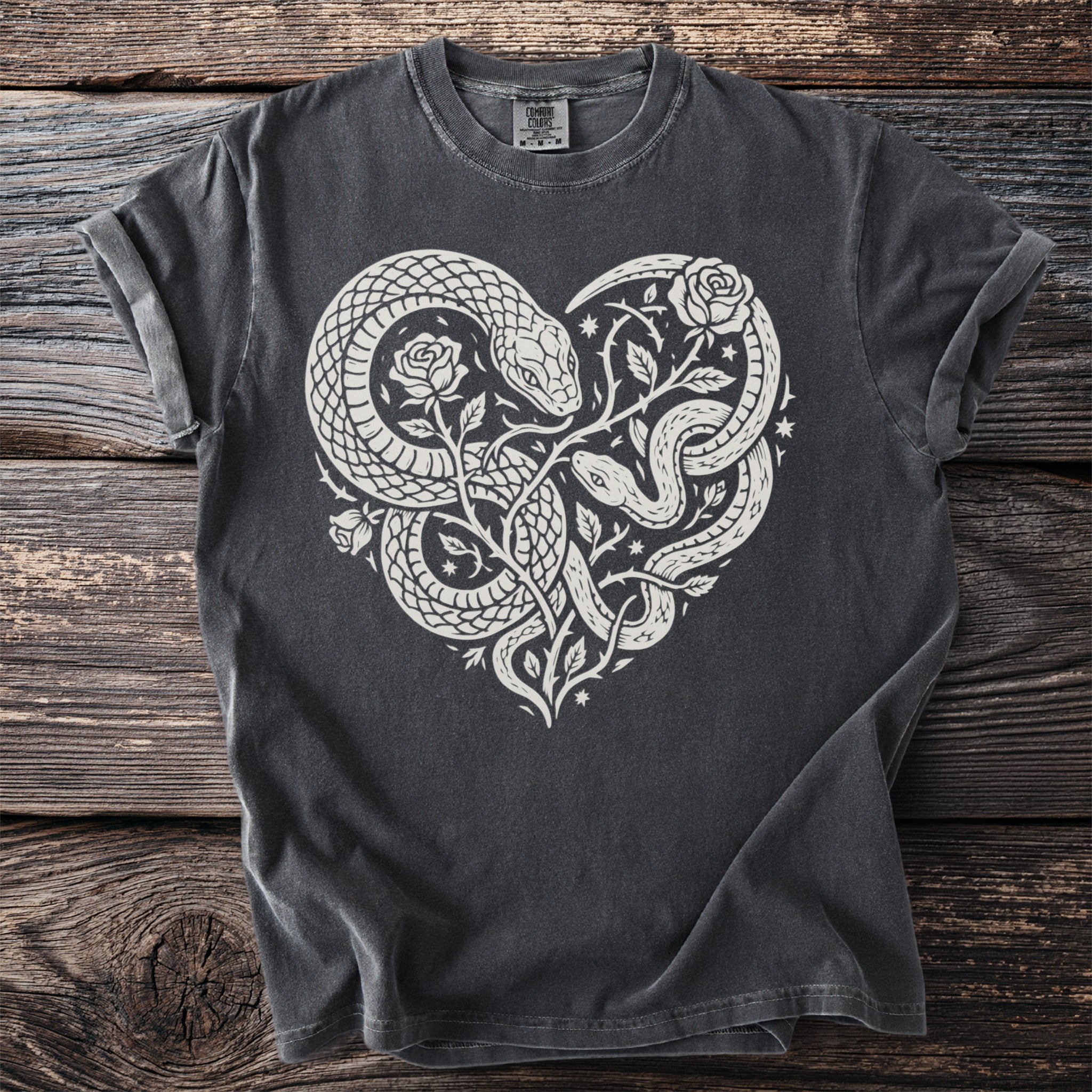 Dark gray t-shirt with white heart design of intertwined snakes and roses.